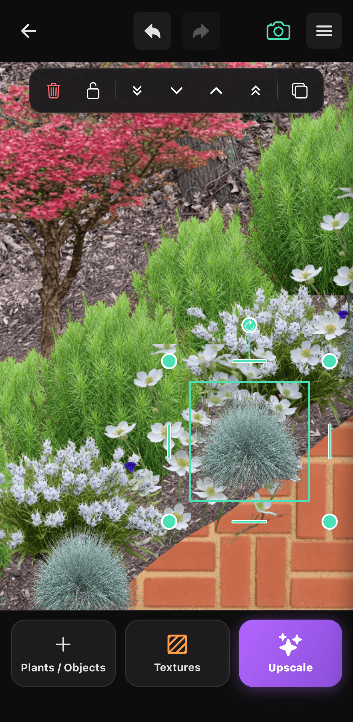 The Sow editor with an ornamental grass selected in a planted border, showing rotate handles and brick paving laid in as a material.